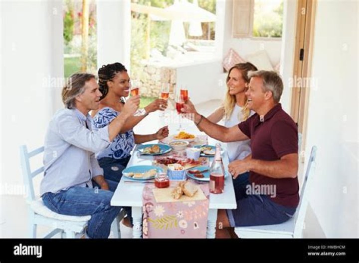 Two couples at a dinner party on a yacht